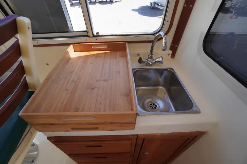 Slide: The Image of 2016 Rosborough 246 Dingby interior with wooden counter, sink, and faucet. - 21