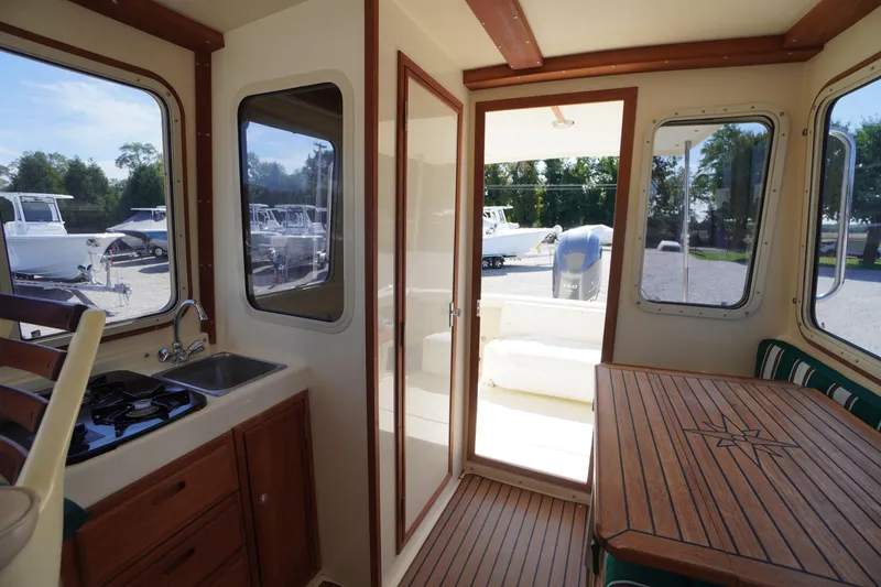 Slide: The Image of Interior of 2016 Rosborough 246 Dingby boat with kitchenette and wooden dining area. - 22