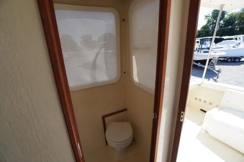 Slide: The Image of 2016 Rosborough 246 Dingby boat interior with compact bathroom and window view. - 24