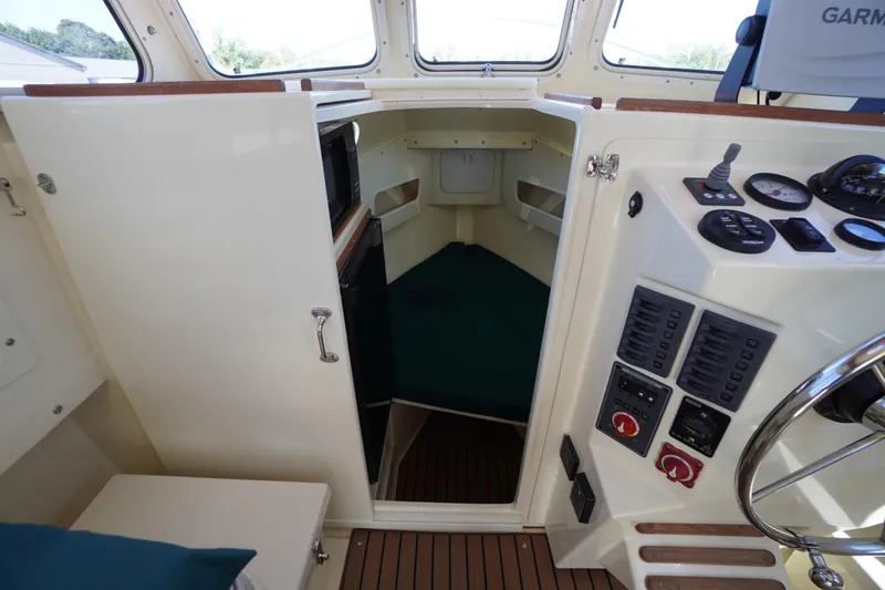Slide: The Image of 2016 Rosborough 246 Dingby boat interior with control panel and cabin view. - 26
