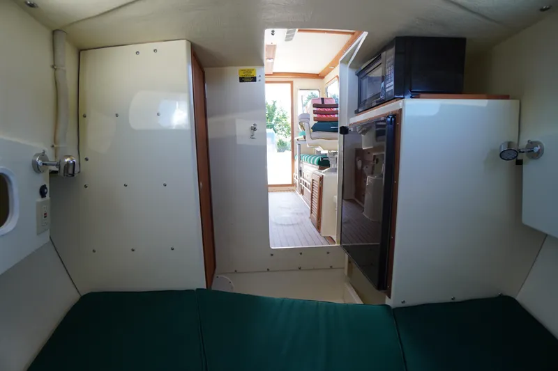 Slide: The Image of Interior of 2016 Rosborough 246 Dingby boat, featuring compact cabin and kitchenette. - 29