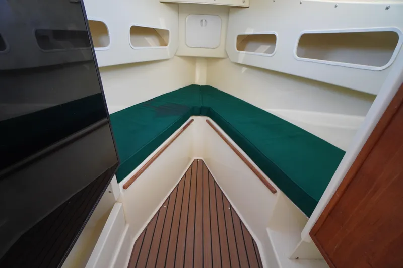 Slide: The Image of 2016 Rosborough 246 Dingby interior with green cushions and wood flooring. - 34