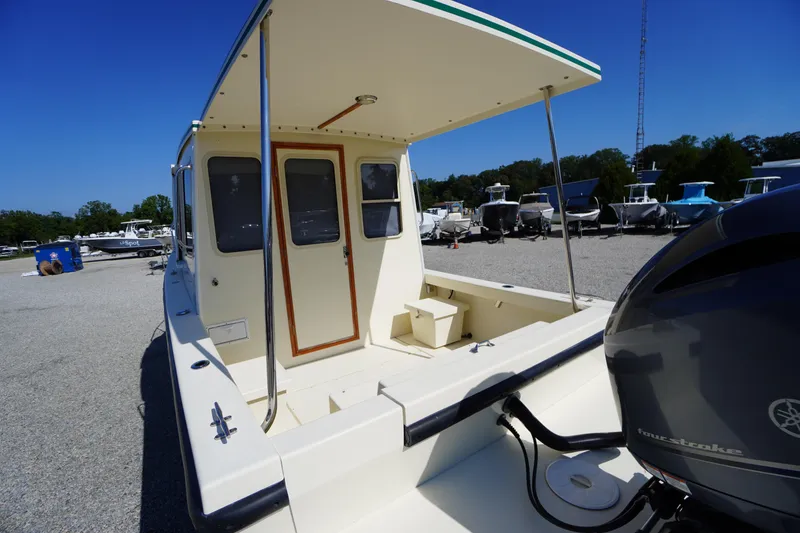 Slide: The Image of 2016 Rosborough 246 Dingby boat with Yamaha outboard motor, docked under clear blue sky. - 39