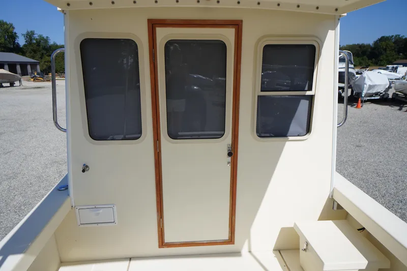 Slide: The Image of 2016 Rosborough 246 Dingby boat cabin with door and windows, parked outdoors. - 41