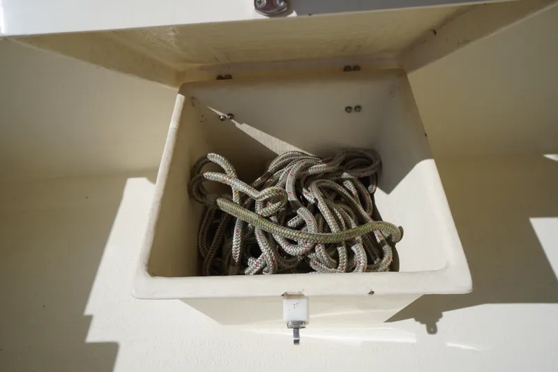 Slide: The Image of Storage compartment with coiled rope on a 2016 Rosborough 246 Dingby boat. - 46