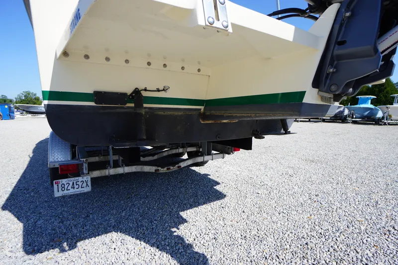 Slide: The Image of 2016 Rosborough 246 Dingby boat on trailer, rear view, parked on gravel. - 48