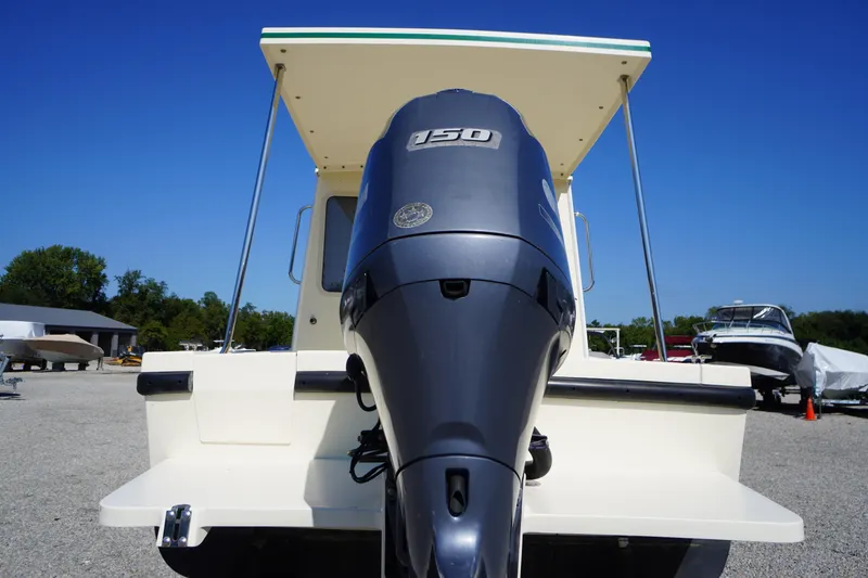 Slide: The Image of 2016 Rosborough 246 Dingby boat with powerful outboard motor, parked outdoors. - 51