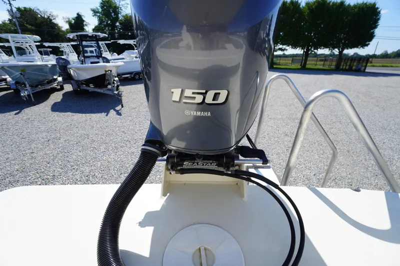 Slide: The Image of 2016 Rosborough 246 Dingby with Yamaha 150 outboard motor, parked on gravel lot. - 53
