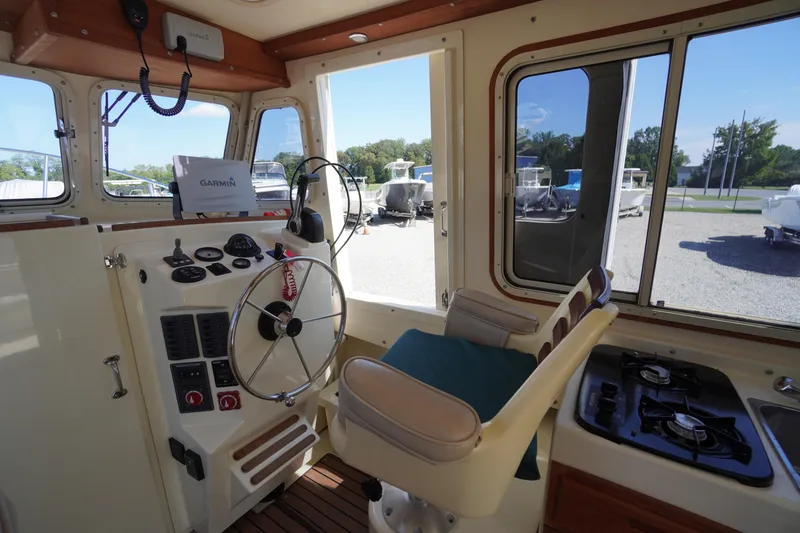Slide: The Image of Interior of 2016 Rosborough 246 Dingby boat with steering wheel, controls, and stove. - 7