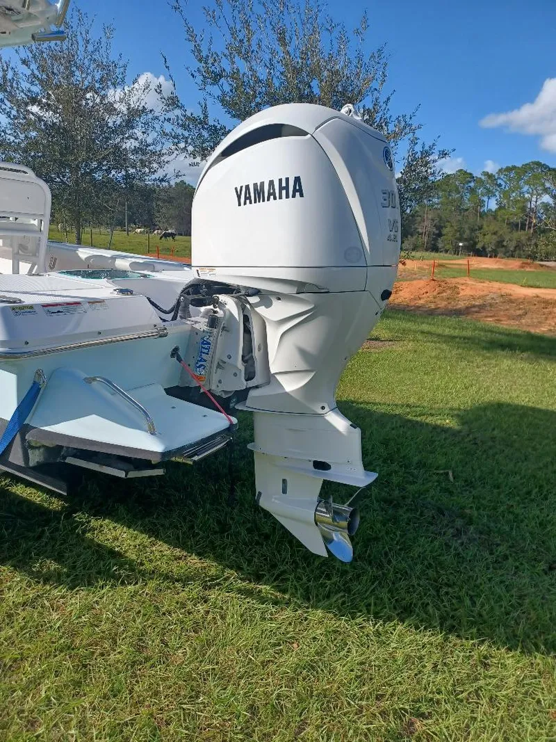 Slide: The Image of 2022 Everglades 243 Center Console with Yamaha outboard motor on grassy area. - 29