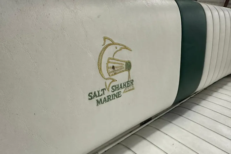 Slide: The Image of White and green boat seat with Salt Shaker Marine logo, model 30, year 2004. - 16