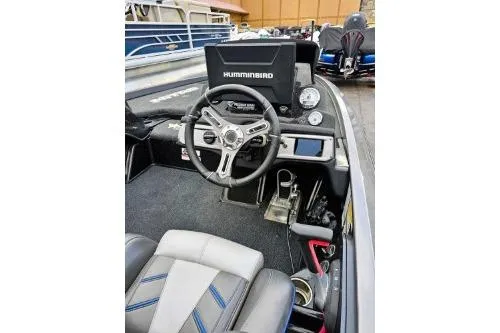 Slide: The Image of 2021 Nitro Z21 Pro boat cockpit with steering wheel and Humminbird display. - 2