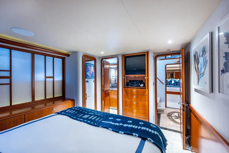 Slide: The Image of Luxurious 2006 Westport 112 yacht bedroom with elegant wood finishes and modern decor. - 47