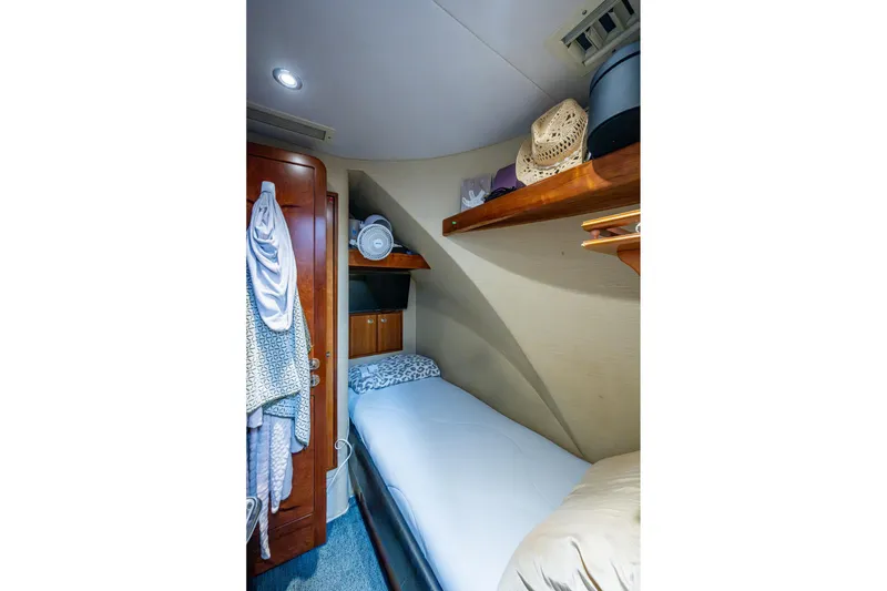 Slide: The Image of Cozy cabin interior of 2006 Westport 112 yacht with single bed and wooden storage. - 116