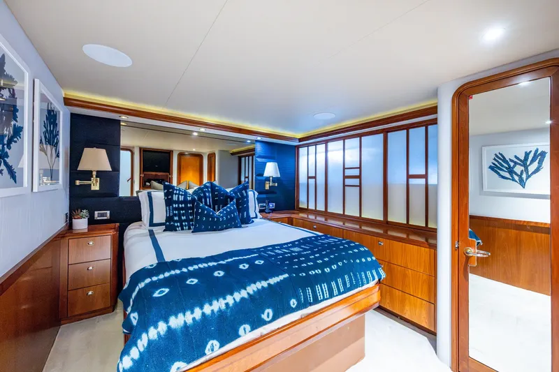 Slide: The Image of Luxurious 2006 Westport 112 yacht bedroom with elegant blue decor and wooden accents. - 44