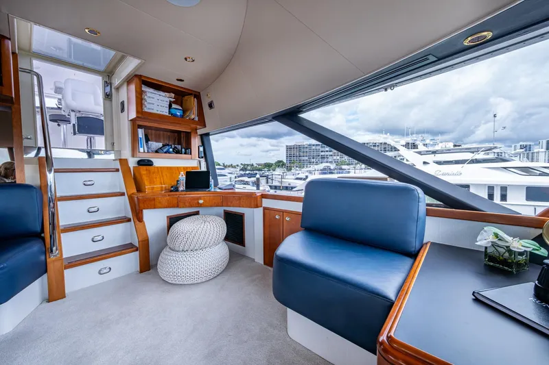 Slide: The Image of Luxurious interior of 2006 Westport 112 yacht with modern seating and marina view. - 71