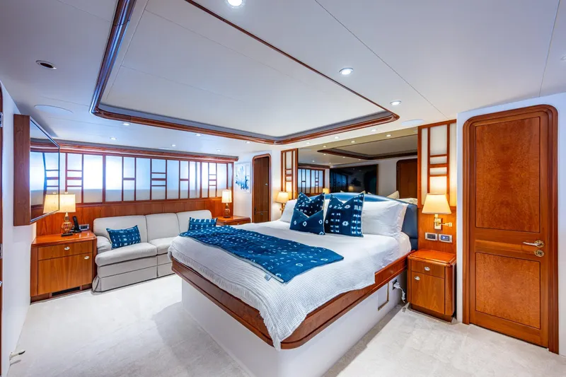 Slide: The Image of Luxurious Westport 112 yacht bedroom, 2006 model, featuring elegant wood accents and plush bedding. - 31