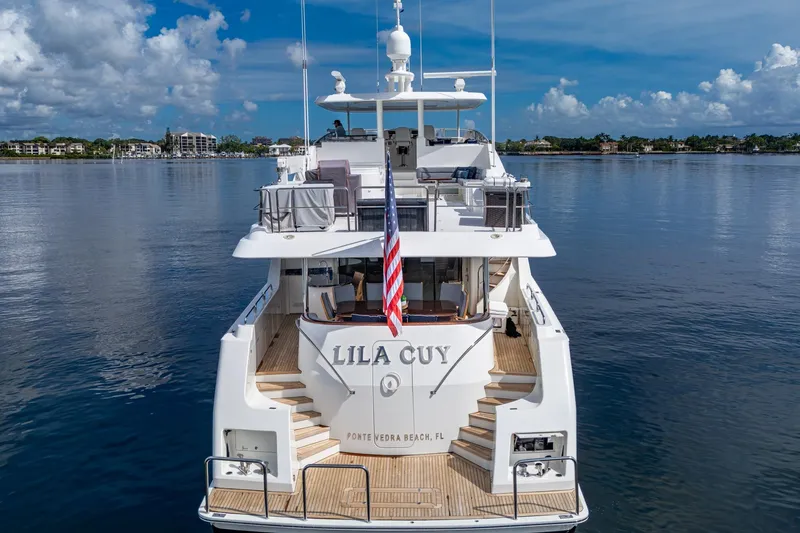 Slide: The Image of Luxury yacht Westport 112, 2006 model, docked with scenic waterfront view. - 2