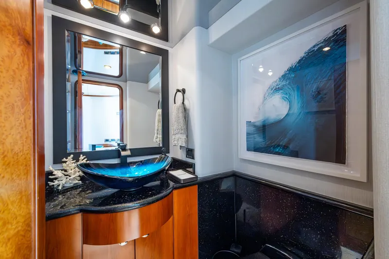 Slide: The Image of Luxurious bathroom on 2006 Westport 112 yacht with modern sink and ocean wave artwork. - 19