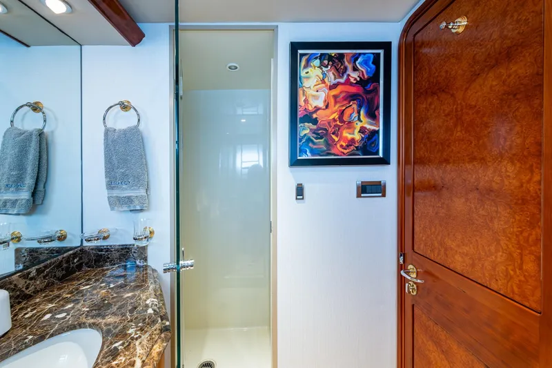 Slide: The Image of Luxurious yacht bathroom with marble countertop, abstract art, and wooden door, Westport 112, 2006. - 51