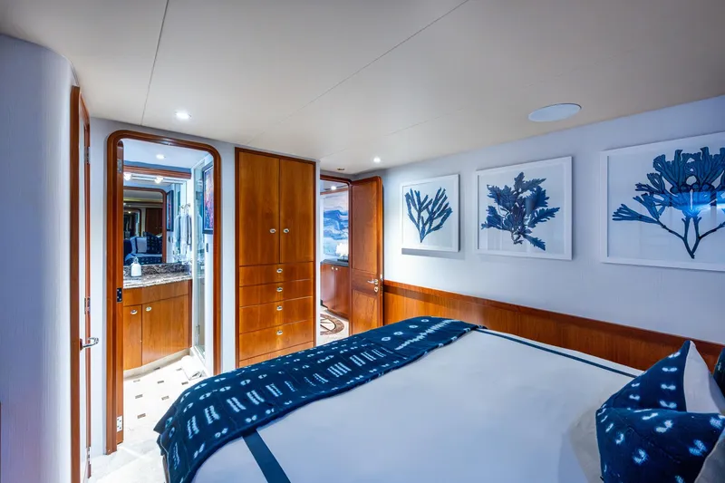 Slide: The Image of Luxurious bedroom interior on 2006 Westport 112 yacht, featuring elegant wood finishes and marine-themed artwork. - 48