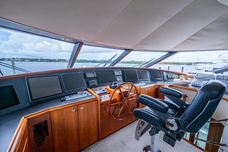 Slide: The Image of Luxurious 2006 Westport 112 yacht helm with modern navigation equipment and panoramic views. - 66