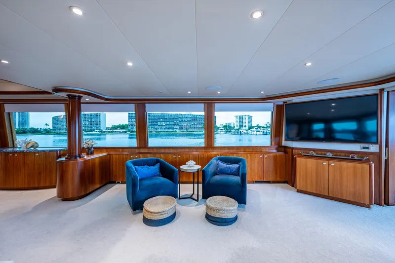Slide: The Image of Luxurious 2006 Westport 112 yacht interior with elegant seating, large windows, and waterfront view. - 6