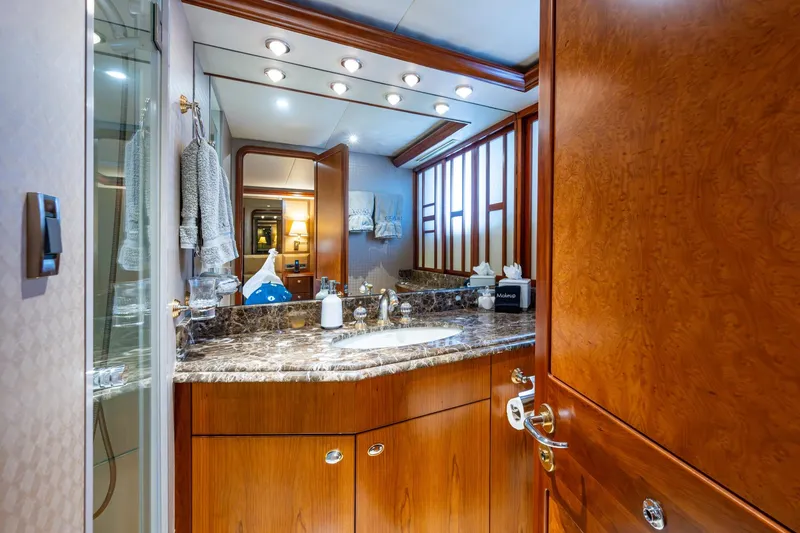 Slide: The Image of Luxurious bathroom interior on 2006 Westport 112 yacht with marble countertop and wooden cabinetry. - 57