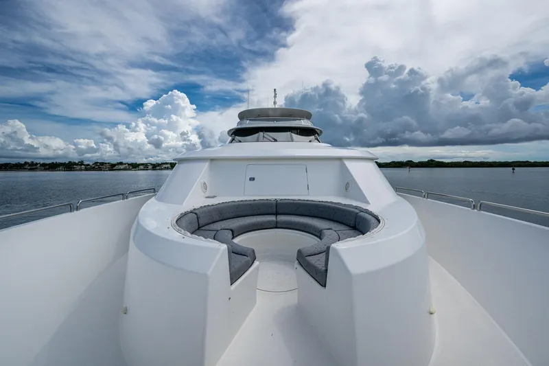 Slide: The Image of Luxurious 2006 Westport 112 yacht with spacious deck seating under cloudy sky. - 102