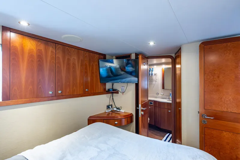 Slide: The Image of Luxurious 2006 Westport 112 yacht bedroom with wood cabinetry and ensuite bathroom. - 113
