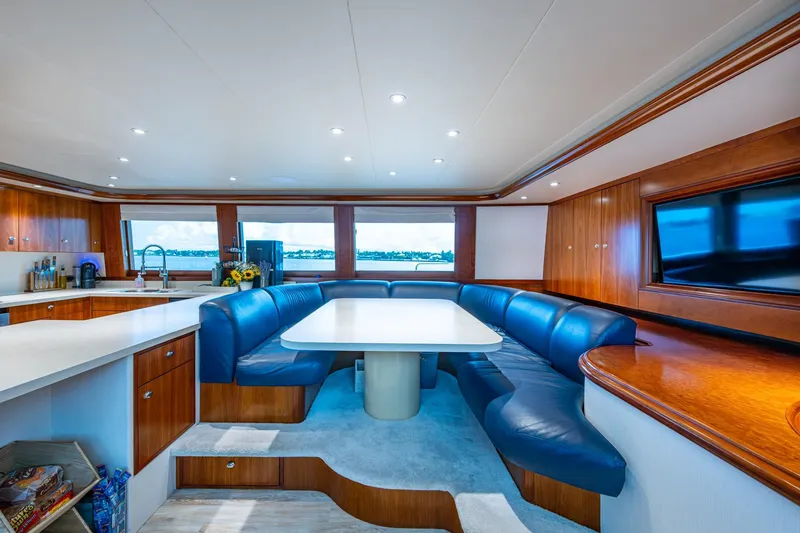 Slide: The Image of Luxurious 2006 Westport 112 yacht interior with elegant dining area and modern kitchen. - 26