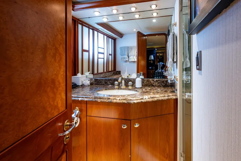 Slide: The Image of Luxurious bathroom interior on 2006 Westport 112 yacht, featuring marble countertop and elegant wood finishes. - 49