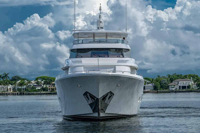 Slide: The Image of Luxurious 2006 Westport 112 yacht on calm waters under cloudy sky. - 1