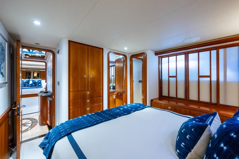 Slide: The Image of Luxurious bedroom interior on 2006 Westport 112 yacht, featuring elegant wood finishes and plush bedding. - 55