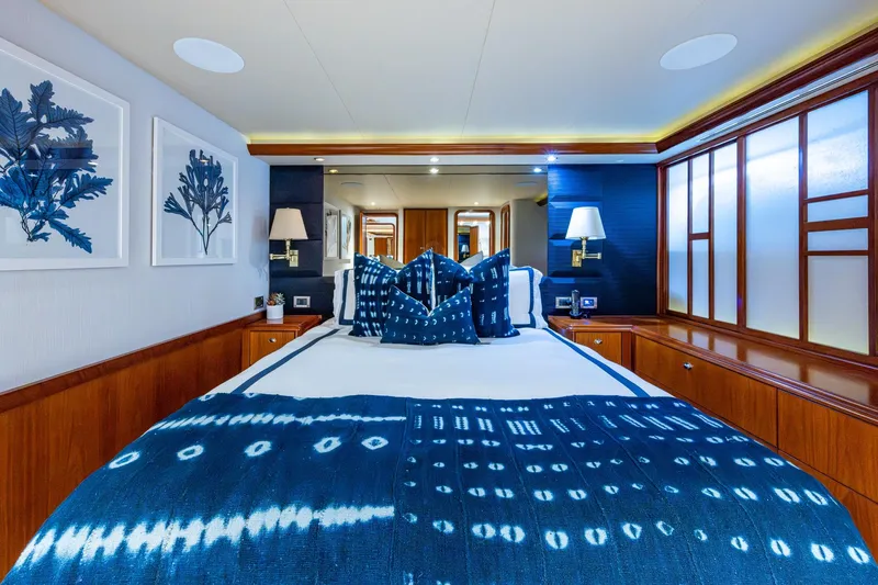 Slide: The Image of Luxurious 2006 Westport 112 yacht bedroom with blue decor and elegant wood accents. - 46