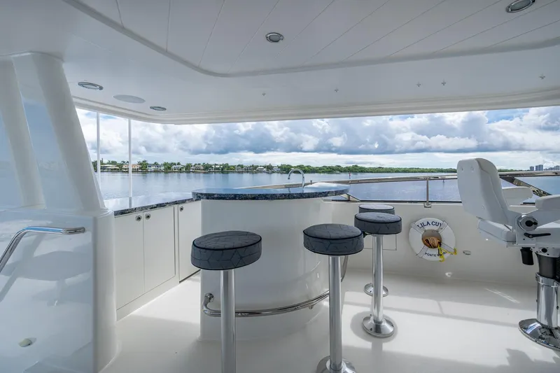 Slide: The Image of Luxurious 2006 Westport 112 yacht deck with bar stools and scenic water view. - 84