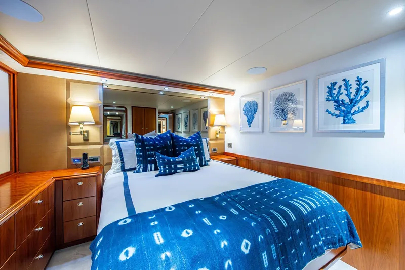 Slide: The Image of Luxurious 2006 Westport 112 yacht bedroom with nautical decor and elegant wood finishes. - 53