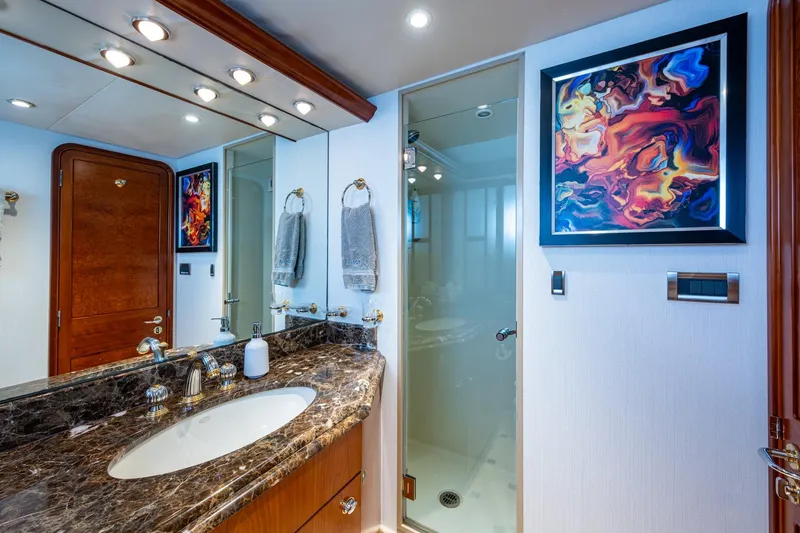 Slide: The Image of Luxurious bathroom on 2006 Westport 112 yacht with marble countertop and abstract art. - 50