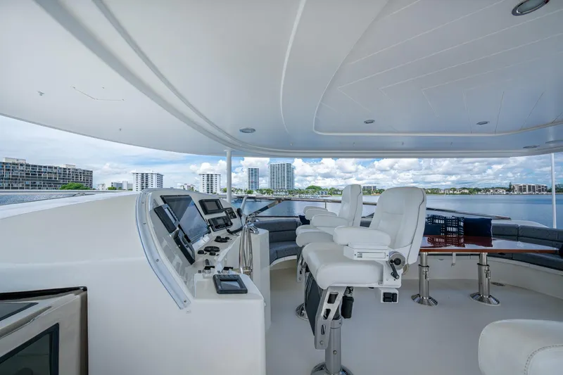 Slide: The Image of Luxurious 2006 Westport 112 yacht helm with modern controls and panoramic waterfront view. - 85