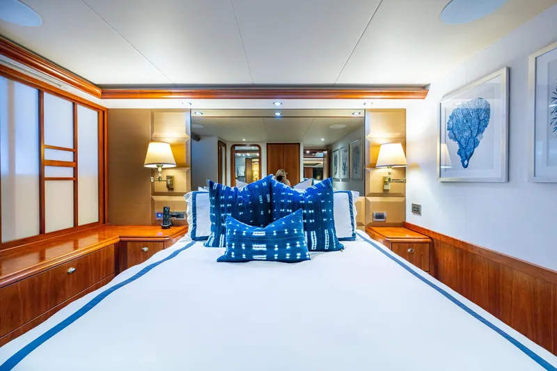 Slide: The Image of Luxurious 2006 Westport 112 yacht bedroom with elegant decor and blue accents. - 54