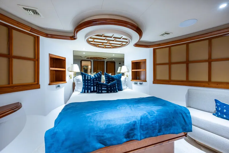 Slide: The Image of Luxurious 2006 Westport 112 yacht bedroom with blue bedding and elegant wood accents. - 60