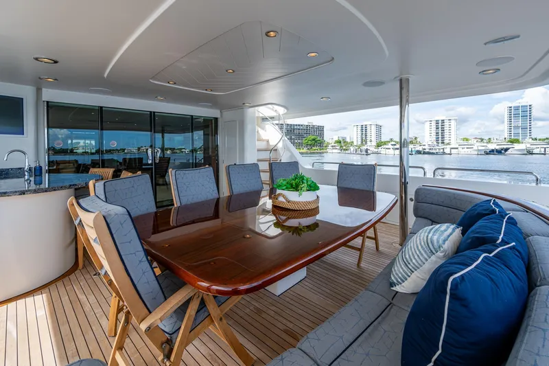 Slide: The Image of Luxurious 2006 Westport 112 yacht deck with elegant dining area and waterfront view. - 94