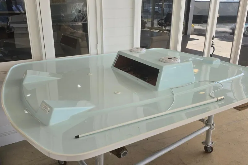 Slide: The Image of 2026 Albury Brothers 27 boat console on display indoors. - 10