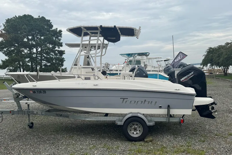 The Image of 2023 Bayliner Trophy T18Bay boat on trailer with Mercury outboard motor. - 1