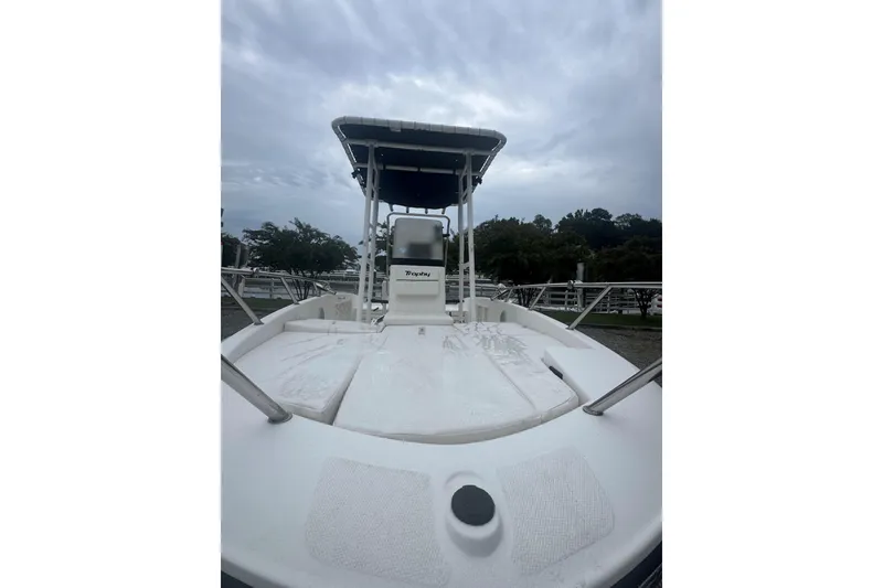 Slide: The Image of 2023 Bayliner Trophy T18Bay boat with T-top, docked under cloudy skies. - 3