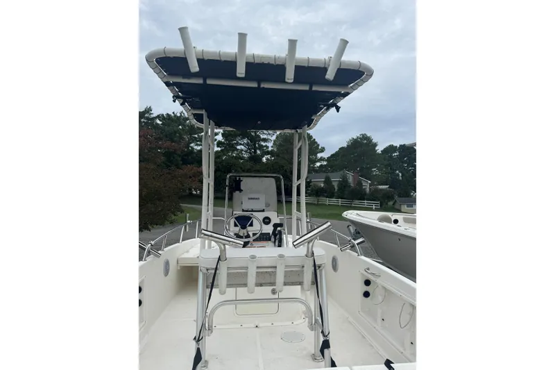 Slide: The Image of 2023 Bayliner Trophy T18Bay boat with T-top and steering console, docked outdoors. - 4