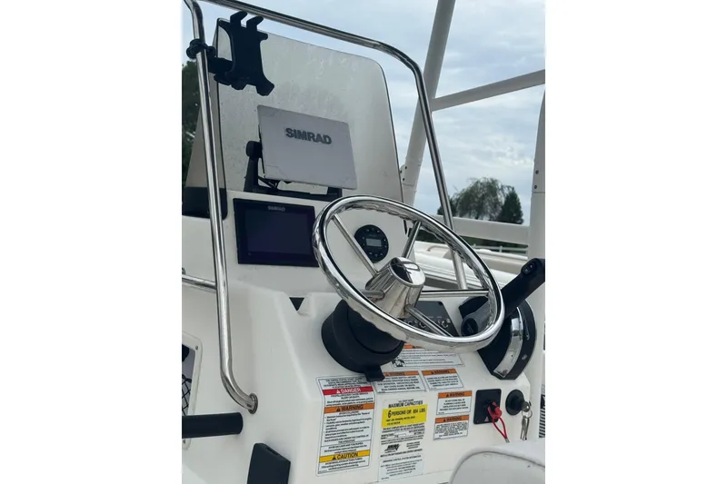 Slide: The Image of 2023 Bayliner Trophy T18Bay boat dashboard with steering wheel and Simrad display. - 5
