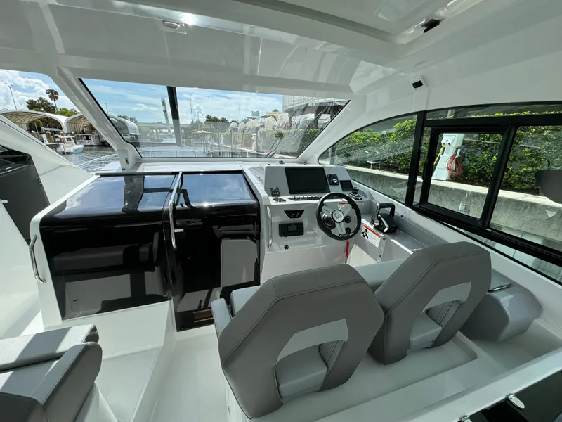Slide: The Image of 2024 Beneteau Gran Turismo 32 cockpit with modern controls and dual seating. - 10