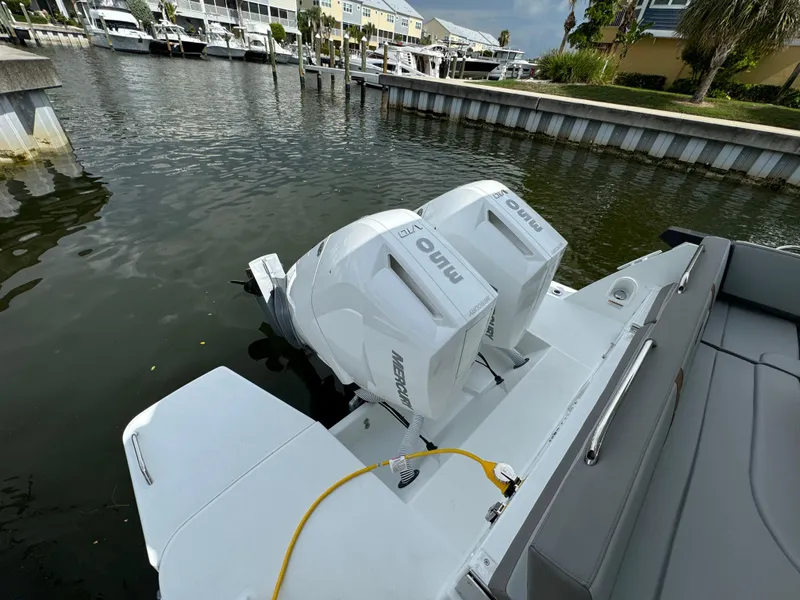 Slide: The Image of 2024 Beneteau Gran Turismo 32 with dual outboard engines docked at marina. - 15