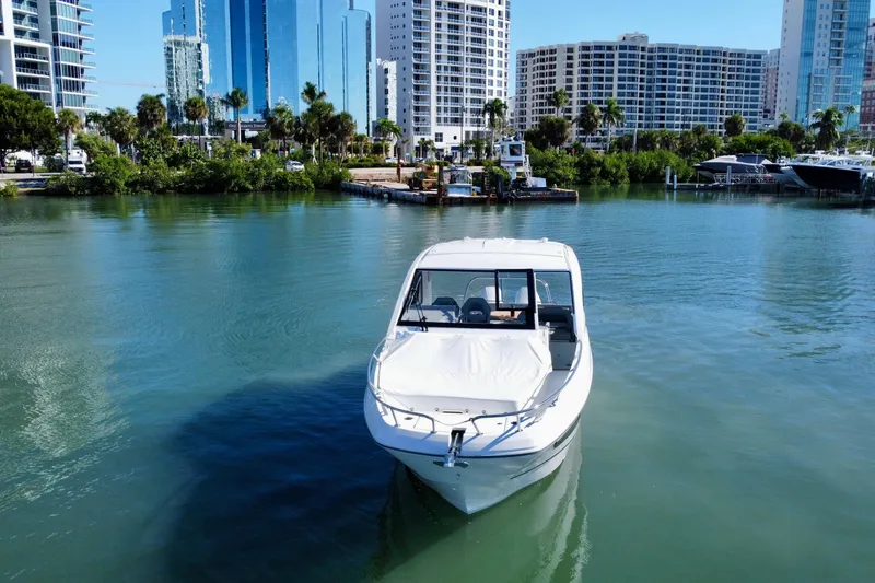 Slide: The Image of 2026 Beneteau Flyer 10 boat on calm water with city skyline background. - 3